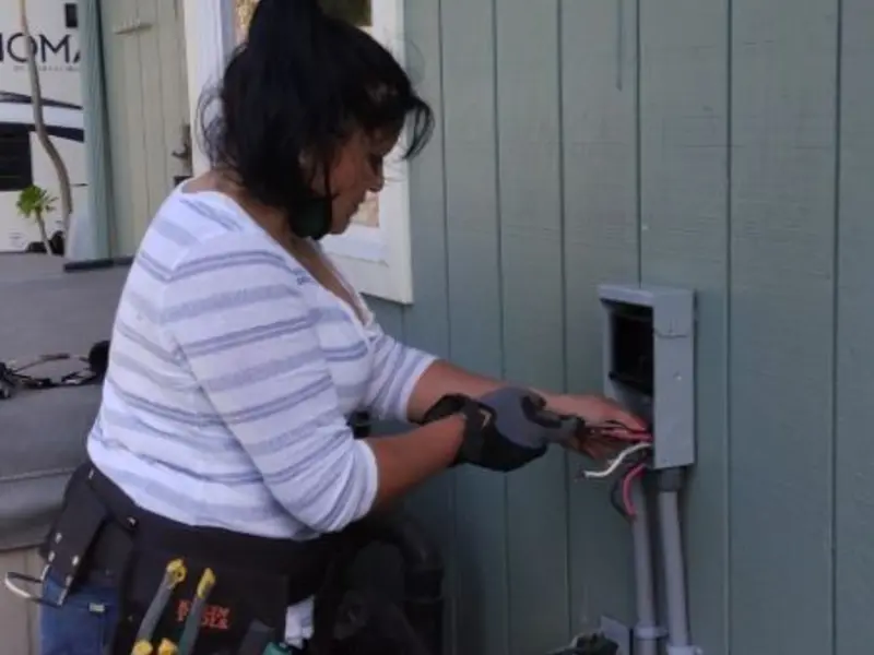 Licensed electrician wiring an exterior subpanel in Sulphur
